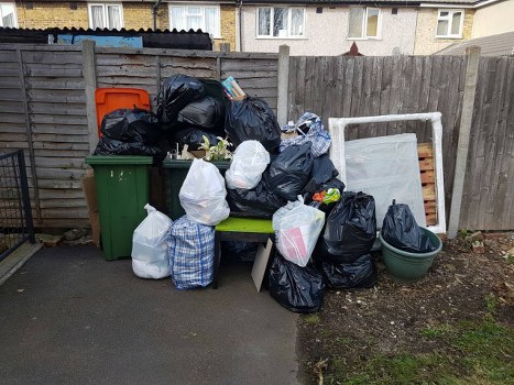 Construction site with builders clearing waste